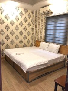 Postel nebo postele na pokoji v ubytování Hotel Quỳnh Anh