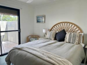 a bedroom with a large bed with pillows on it at Captains Nook Cowes in Cowes