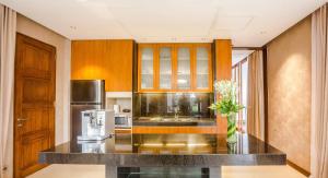 a kitchen with a counter top and a refrigerator at Holiday Inn Resort Baruna Bali, an IHG Hotel - CHSE Certified in Kuta