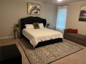 a bedroom with a large bed and a couch at Beautiful Home with Modern Rooms in Round Rock