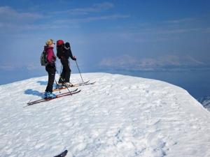 two people standing on top of a snow covered mountain at 6 person holiday home in Nord Lenangen in Sørlenangen