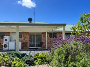 a brick house with a appliance on a patio at Montrose holiday cottage in Rosetta