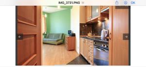 a kitchen with wooden cabinets and a stove top oven at Apartamenty Viva Maria in Zakopane
