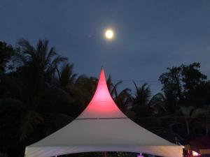 a white tent with the moon in the sky at Casa Aba Matapalo in Matapalo