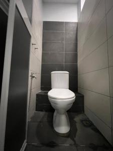 a bathroom with a white toilet in a stall at MyPods @ Bukit Bintang in Kuala Lumpur