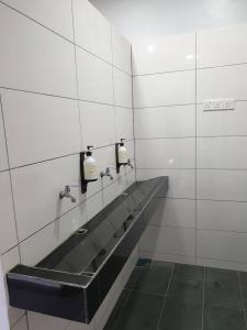 a public bathroom with two sinks and two mirrors at MyPods @ Bukit Bintang in Kuala Lumpur