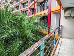 a palm tree in front of a building at MBC Mai Khao Beach Condotel LUXURY APARTMENTs in Phuket Town