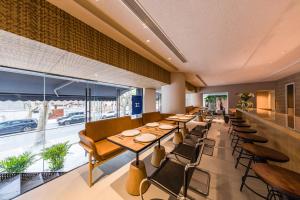 a restaurant with tables and chairs and a large window at Atour X Shanghai Huaihai Middle Road in Shanghai