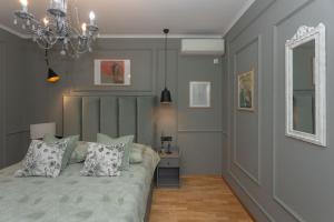 a bedroom with a bed and a chandelier at The Residence in Šibenik