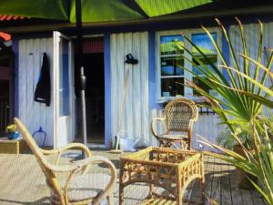 a group of chairs and a table on a porch at Svängen B&R in Sydkoster