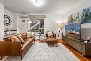 a living room with a couch and a tv at StayCentral - Brunswick Vibe Parkville in Melbourne