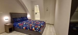 a bedroom with a bed with a colorful comforter at Highly finished Studio Home in Valletta in Valletta