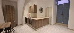 a kitchen with a counter and a table and a door at Highly finished Studio Home in Valletta in Valletta