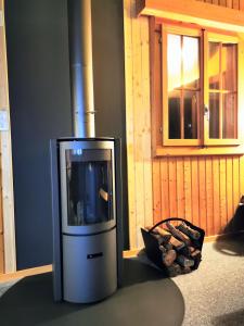 a tv sitting in a room with a pile of wood at Ferienwohnung im Chalet am Bach in Schwarzsee