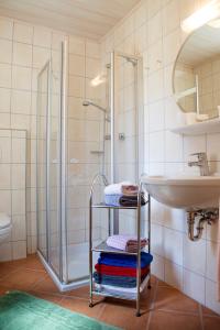 a bathroom with a shower and a sink and towels at Aignerhof in Kirchberg