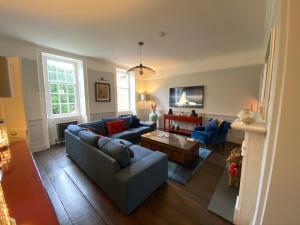 a living room with a couch and a table at Beautiful Georgian House located in Blandford in Blandford Forum