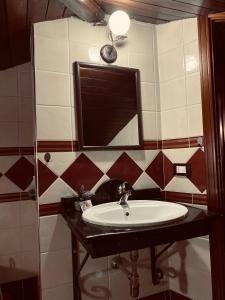 a bathroom with a sink and a mirror at Home Ilardo in Campobello di Licata