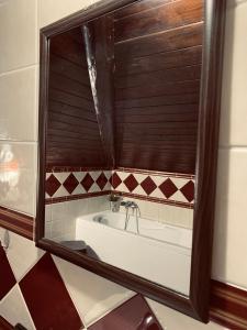 a bath tub in a bathroom with a mirror at Home Ilardo in Campobello di Licata