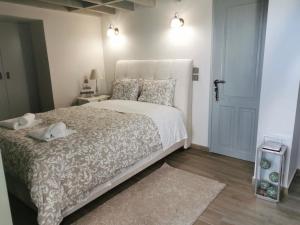 a bedroom with a large white bed and a door at Casa Carina, Arachova in Arachova