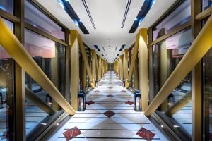 a hallway of a building with a tiled floor at Gevora Hotel in Dubai