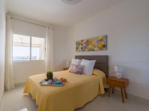 a bedroom with a bed with a tray on it at Mogan Beach Blue Sky in Mogán