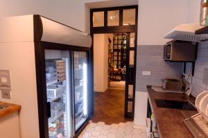 a kitchen with an open refrigerator in a kitchen at Prague Dream Hostel in Prague