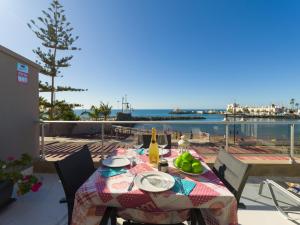 a table with a plate of food and a view of the ocean at Mogan Beach Blue Sky in Mogán +31 photos