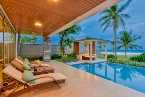 an outdoor patio with a swimming pool and a villa at Ocean Luxury Villas Danang in Da Nang