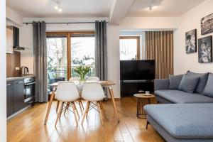 Televízia a/alebo spoločenská miestnosť v ubytovaní udanypobyt Apartamenty Tuwima