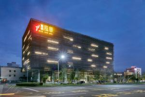 a large building with a sign on the side of it at Orient Luxury Hotel in Chiayi City