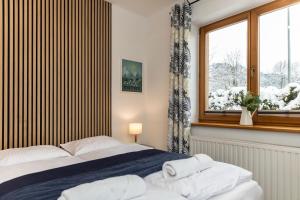 Posteľ alebo postele v izbe v ubytovaní udanypobyt Apartamenty Tuwima