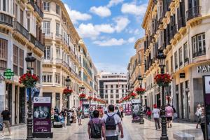 people walking down a street in a city with buildings at Apartment Casa Riad with spacious patio - TCM in Málaga