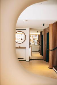 a mirror reflecting a room with a bed at Hôtel & Spa Belle Plage in Cannes
