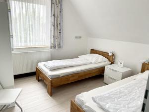 Postel nebo postele na pokoji v ubytování Haus Schwalbennest