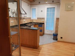 a kitchen with wooden cabinets and a stove top oven at Offer Economic apartment Barcelona in Barcelona