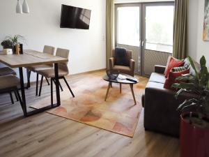 salon z kanapą i stołem w obiekcie Lechappart w mieście Höfen