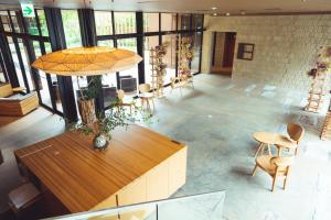 a large room with a table and chairs and windows at SETRE Naramachi セトレ ならまち in Nara