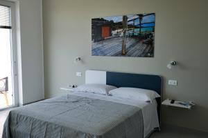 a bedroom with a bed with a painting on the wall at Villa Caravaggio Comfort e Relax in Rocca San Giovanni