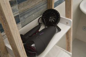 a hair dryer sitting on a shelf in a bathroom at Villa Caravaggio Comfort e Relax in Rocca San Giovanni