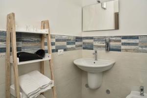 a bathroom with a sink and a mirror at Villa Caravaggio Comfort e Relax in Rocca San Giovanni +37 photos