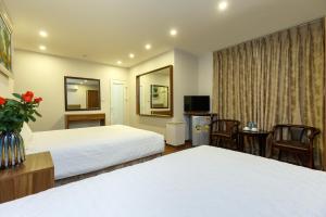 Giường trong phòng chung tại OYO 1158 Ngoc Trai Hotel & Apartment