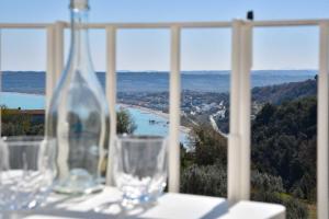 two wine glasses sitting on a table in front of a window at Villa Caravaggio Comfort e Relax in Rocca San Giovanni