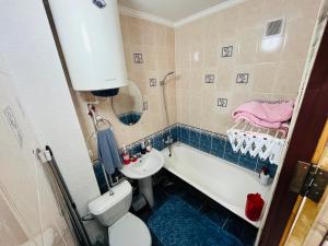 a bathroom with a tub and a sink and a toilet at Апартаменты Ермекова 23 in Karagandy