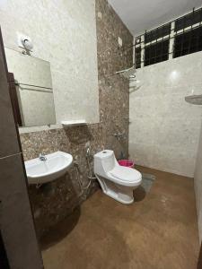 a bathroom with a toilet and a sink at Delta Hospitality - Sea facing rooms with a PRIVATE BEACH in Kalyānpur