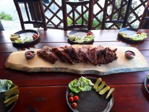 a table topped with meat and plates of food at Penzion u Balcarky in Ostrov u Macochy