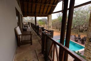 a balcony of a house with a swimming pool at The Citrine House 33 in Mabula