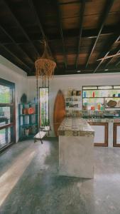 a large kitchen with a chandelier hanging from the ceiling at Secret Pool Villa Tuason Beach in General Luna