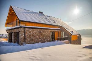 a building with snow on the ground in front of it at Czorsztyn Prestige Apartamenty in Czorsztyn +111 photos