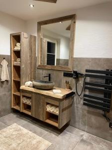 a bathroom with a sink and a mirror at Haus Almweg in Kirchberg in Tirol
