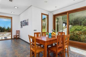 a dining room with a wooden table and chairs at Villa Anis - PlusHolidays in Calpe